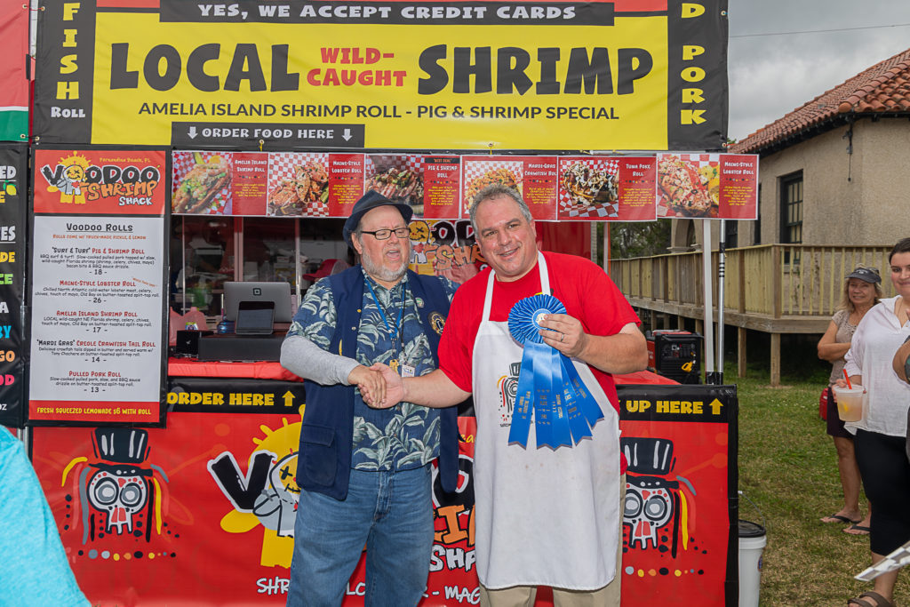 William Frederico (right) accepts 1st place ribbons for Best Shrimp Dish (Amelia Island Shrimp Roll) and best fish dish (Tuna Poke Roll) from St Augustine Lion's organizer Dominic Mercurio